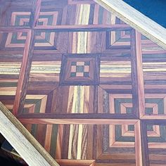 a close up of a piece of wood that has been cut into squares and rectangles