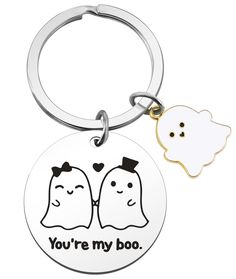 two ghost keychains with the words you're my boo on them and a white