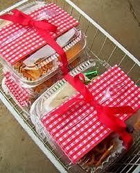 three baskets filled with food wrapped in red and white checkered paper