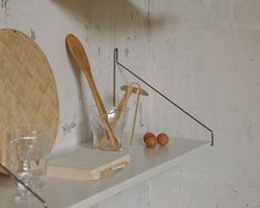 a shelf with utensils and other items on it