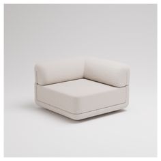 the corner chair is made out of white fabric and has a rounded seat cushion on it