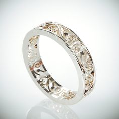 an intricately designed wedding ring on a white background