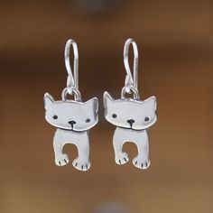 Cute kittens gaze outward in this adorable pair of earrings.  They are 3/4 of an inch tall and made completely from sterling silver with solid sterling French ear wires. For the matching necklace go here: https://www.etsy.com/listing/1731217710/tiny-dancing-cat-charm-necklace-adorable I ship First Class Mail with tracking in a gift box. In stock and ready to ship. To see my entire store go here:  https://www.etsy.com/shop/marmar To see my gemstone and modern store go here: https://www.etsy.com/s Nickel-free Sterling Silver Novelty Earrings, Novelty Sterling Silver Nickel-free Earrings, Nickel Free Sterling Silver Novelty Earrings, Nickel Free Novelty Sterling Silver Earrings, Playful Silver Earrings, Novelty Sterling Silver Hypoallergenic Earrings, Silver Playful Earrings, Novelty Hypoallergenic Sterling Silver Earrings, Hypoallergenic Novelty Sterling Silver Earrings