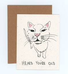 a card with an image of a cat that says heard you're old on it