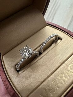 two wedding rings in a box on display