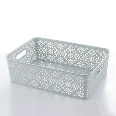 a white plastic basket with an intricate design