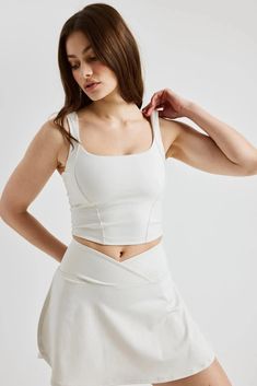 Our sporty take on the fitted and ultra-fem corset. The Corset Tank doubles as a bra and top with 1 ½” shoulder straps, princess seam stitch details, and an inside built-in bra. Made with Recycled Poly. Square scoop neck 15 ½” L Low impact Lined 84% Recycled Polyester 14% Spandex Medium weight with just enough stretch for flexibility 84% Recycled Polyester 14% Spandex Machine wash cold, lay flat dry Made in the USA Fitted Yoga Tank Top With Built-in Padding, Fitted Yoga Top With Built-in Padding, Fitted Tank Sports Bra With Built-in Bra, Fitted Athleisure Tank Top With Built-in Bra, Fitted Tank Top With Built-in Padding, Sleeveless High Stretch Crop Top With Built-in Padding, Cropped Top With Built-in Bra And Fitted Bodice, Fitted Activewear With Built-in Padding And Tank Straps, Fitted White Sports Bra With Built-in Bra