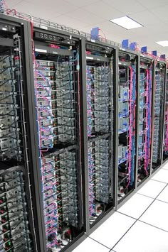 rows of servers in a data center with wires and other electronic equipment on the racks