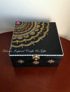 a decorative box sitting on top of a wooden table