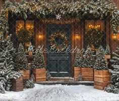 christmas decorations on the front door of a building with lights and wreaths around it