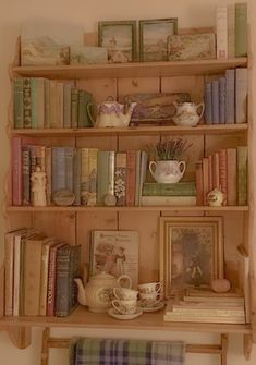 a book shelf filled with books and pictures