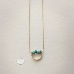 Description A line of semi-precious pebbles create the horizon of this gemstone necklace. Brass curved bar with 14K gold dipped chain. Choose your length. Spring ring closure. You choice of clear quartz, unakite, aquamarine or turquoise semi-precious stone. WHAT IS GOLD DIPPED? Gold dipped is the best alternative to solid gold, and that's why we use gold dipped metals in our jewelry designs. Our gold dipped jewelry components have 150-200 layers of pure solid gold over a base metal. Unlike gold-