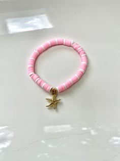 This bracelet is made out of stretchy string and clay beads. It's so pretty for summer! All orders will recieve 2 stickers and a ring for free. Starfish Clay Bead Bracelet, Clay Bead Bracelets Ideas, Snowflake Making, Clay Bead Ideas, Bracelet Stuff, Make Clay Beads, Pink Starfish, Clay Bead Bracelet Ideas, Bracelet Business