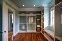 an empty walk in closet with wooden floors