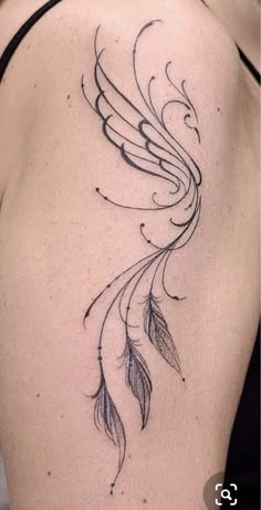 the back of a woman's shoulder with a tattoo design on it