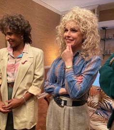 three women standing next to each other in front of couches and chairs with their hands on their chins