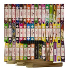 several stacks of incense sticks are stacked on top of each other in front of a white background