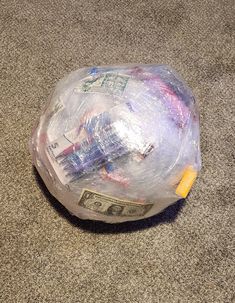 a plastic bag filled with money sitting on the floor