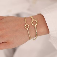 "Embrace the perfect fusion of sophistication and boldness with our exquisite 14K Gold Sailor Lock Snake Bracelet. Meticulously crafted with meticulous attention to detail, this bracelet showcases a distinctive sailor lock clasp, infusing a touch of nautical charm into its design. The sleek snake chain adds a contemporary and fashion-forward element, allowing for versatile styling options. Crafted from premium materials with unparalleled craftsmanship, this bracelet not only elevates your style Modern Jubilee Bracelet With Snake Chain, Modern Bangle Jewelry With Lobster Clasp, Fine Jewelry Charm Bracelet With Jubilee Design, Formal Flexible Snake Chain Bracelet, Tarnish Resistant Round Bangle, Modern Snake Chain Bracelet For Formal Occasions, Modern Snake Chain Bracelet For Formal Events, Modern Bangle Bracelet With Lobster Clasp, Flexible Gold Bracelet For Anniversary