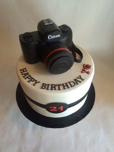 a birthday cake with a camera on top