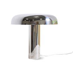 a chrome plated table lamp on a white background