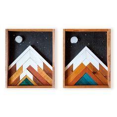 two pieces of art made out of wood with mountains and stars in the sky behind them