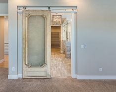 an open door leading to a closet in a house with wood floors and white walls