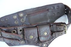 a brown leather belt with metal rivets and buckles on the inside of it