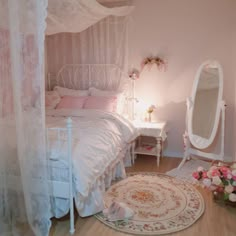 a white bed sitting in a bedroom next to a mirror