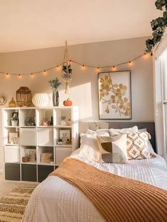 a bedroom with lights strung above the bed