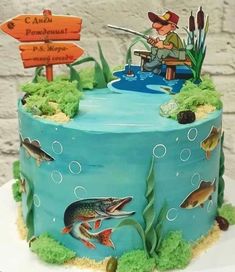 a birthday cake decorated with an image of a fisherman on the lake and fish in the water