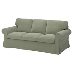 a green couch sitting on top of a white floor