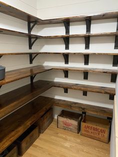 the inside of a storage room with wooden shelves