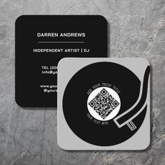 two black and white business cards sitting on top of each other, one with a qr code in the middle