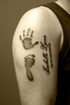 a man with a tattoo on his arm that has a hand and foot print