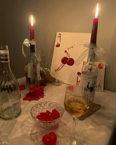 a table topped with wine glasses and bottles filled with liquid sitting next to each other