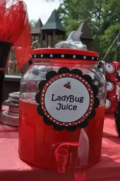 a ladybug juice jar sitting on top of a table