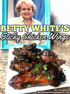 betty white's sticky chicken wings recipe on a plate with the cover of her cookbook