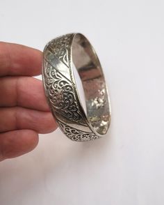 Vintage Berber cuff bracelet in silver with floral motifs - Essaouira - Morocco  Early 20th century,  Inner diameter: 6.3 cm (2.36 inches) Width: 1.9 cm (0.75 inche) Circumference (wrist circumference): 19.78 cm (7.50 inches ) Total weight: 68.10 grams Feel free to contact me for any question about this item, I will be happy to answer you as soon as possible. Visit my Etsy Shop: https://www.etsy.com/fr/shop/TIFINAGH Réf : 18 / B2 Elegant Engraved Cuff Bracelet For Festivals, Traditional Silver Bracelets For Wedding, Traditional Oxidized Bracelets For Formal Occasions, Antique Silver Bangle As Gift, Traditional Engraved Bangle For Formal Occasions, Elegant Heavy Silver Bangle, Engraved Metal Bangle For Wedding, Wedding Engraved Metal Bangle, Traditional Cuff Bracelet For Formal Festivals