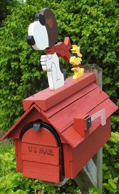 a red mailbox with a dog on top