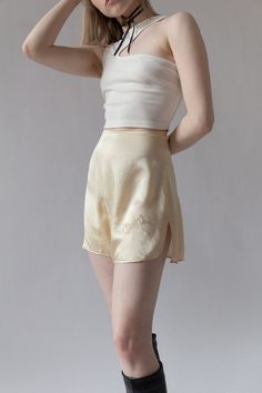 "Bridal silk tap shorts for \"Chippy\" from Bergdorf Goodman in the 1920s. Complete with custom embroidery and tiny mother of pearl buttons at side. The softest cream silk. Very wearable for today and in excellent shape. BRAND / Bergdorf Goodman MATERIAL / 100% Silk CONDITION / Some minor discolorations on back but overall in excellent shape for their age. SIZE / US 0 MEASUREMENTS / Waist - 24\" / Hip - 36\" Nicolette is a size 24 and 5'3" Silk Bottoms For Summer Daywear, Summer Silk Bottoms For Daywear, Fitted Silk Cream Bottoms, Fitted Silk Bottoms Short Length, Elegant Fitted Cream Shorts, Chic Silk Shorts, Summer Silk Cream Bottoms, Cream Silk Bottoms For Summer, Summer Cream Silk Bottoms