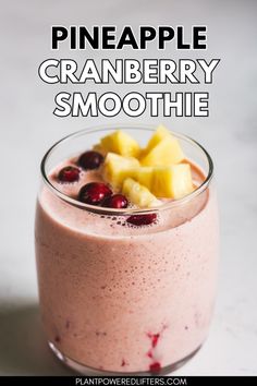 a smoothie with cranberry and pineapple is in a glass on the table