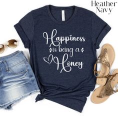 Celebrate the sweetness of being a "Honey" with this custom t-shirt! Our custom "Happiness is being a Honey" shirt is the perfect gift for your loved one or for yourself. This Honey T-shirt is a unique and thoughtful gift for any occasion, whether it's Mother's Day, a pregnancy reveal, or just because. Show your honey how special they are with this one-of-a-kind shirt that will bring a smile to their face every time they wear it. Let happiness buzz around you with this adorable Honey Tshirt that Honey Shirt, Honey Gifts, Pregnancy Reveal, Pregnancy Reveals, Baby Bag, Happiness Is, Small Designs, San Jose Ca, Sizing Chart