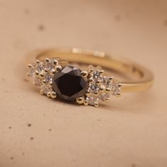 The Julie Ring is from our vintage collection, a delicate beautiful design. Set with a Black diamond in the center and five stunning white diamonds on each side. She's a show stopper just like you. All features can be customized! please contact us if you wish to make changes, we love making custom designs. All of our jewelry is carefully handmade in our atelier *HC diamond are all conflict free diamonds To order by phone click here>> +972(0)722991000 Anniversary Rings With Diamond Accents And Black Spinel, Anniversary Black Spinel Rings With Diamond Accents, Elegant Black Spinel Diamond Ring For Anniversary, Wedding Rings With Diamond Accents And Black Spinel, Black Spinel Rings With Diamond Accents For Wedding, Classic Black Spinel Diamond Ring For Anniversary, Luxury Black Spinel Diamond Ring For Anniversary, Elegant Black Spinel Diamond Ring For Wedding, Black Diamond Ring With Rose Cut For Anniversary