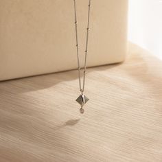 Our Labradorite & Moonstone Drop Necklace showcases the deep, earthy tones of the Labradorite Quartz and the milky, iridescent glow of the Moonstone. This unique blend of stones captures the essence of the earth and the moon, embodying grounded elegance and celestial charm. Perfect for day or night, this enchanting necklace adds a touch of natural elegance to any outfit ✨ SKU: RR-NR204 Product Details Material: High Quality Solid 925 Sterling Silver Finish: 18K Gold ∙ Sterling Silver Featuring a Initial Tag Necklace, Dainty Initial Necklace, Moonstone Pendant, Drop Necklace, Tag Necklace, Multi Strand, Earthy Tones, Initial Necklace, Solid 925 Sterling Silver