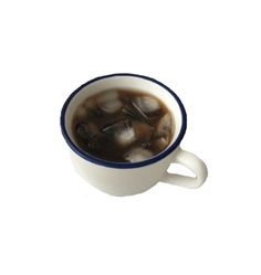 a cup filled with ice sitting on top of a white table