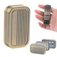 a hand holding a gold colored lighter next to three different types of electronic gadgets