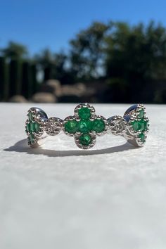 A timeless and elegant design, symbolizing wealth and harmony. Perfect for everyday wear or dressed up for special occasions. Make a bold statement in our Emerald and Diamond Clover Ring, handcrafted in 14k white gold. Item Specifications: Materials: 14k Solid White Gold  Gemstone: Natural Emeralds and Natural Diamonds Total Gold Weight: 2.22 ct. Total Diamond Carat Weight: 0.03 ct. Total Emerald Carat Weight: 0.34 ct. Emerald Diameter: 5.6 mm x 5.6 mm Diamond Clarity: SI 1-2 Diamond Color: G co Heirloom Style Emerald Ring In White Gold For Promise, Heirloom White Gold Emerald Ring For Promise, Heirloom Style White Gold Emerald Promise Ring, Heirloom White Gold Emerald Promise Ring, Luxury Sterling Silver Emerald Ring With Prong Setting, Luxury Emerald Ring With Prong Setting In Sterling Silver, Luxury 14k White Gold Green Diamond Ring, Luxury Green Diamond Ring In 14k White Gold, White Gold Emerald Ring With Polished Platinum Finish