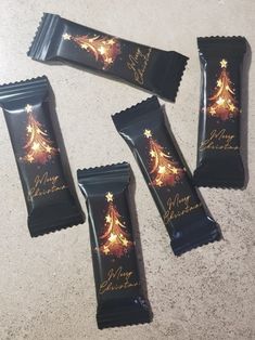 four chocolate bars sitting on top of a counter next to each other with christmas decorations