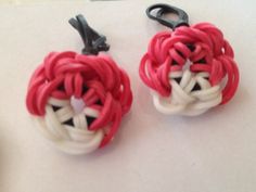 two red and white hair clips sitting on top of a table next to each other